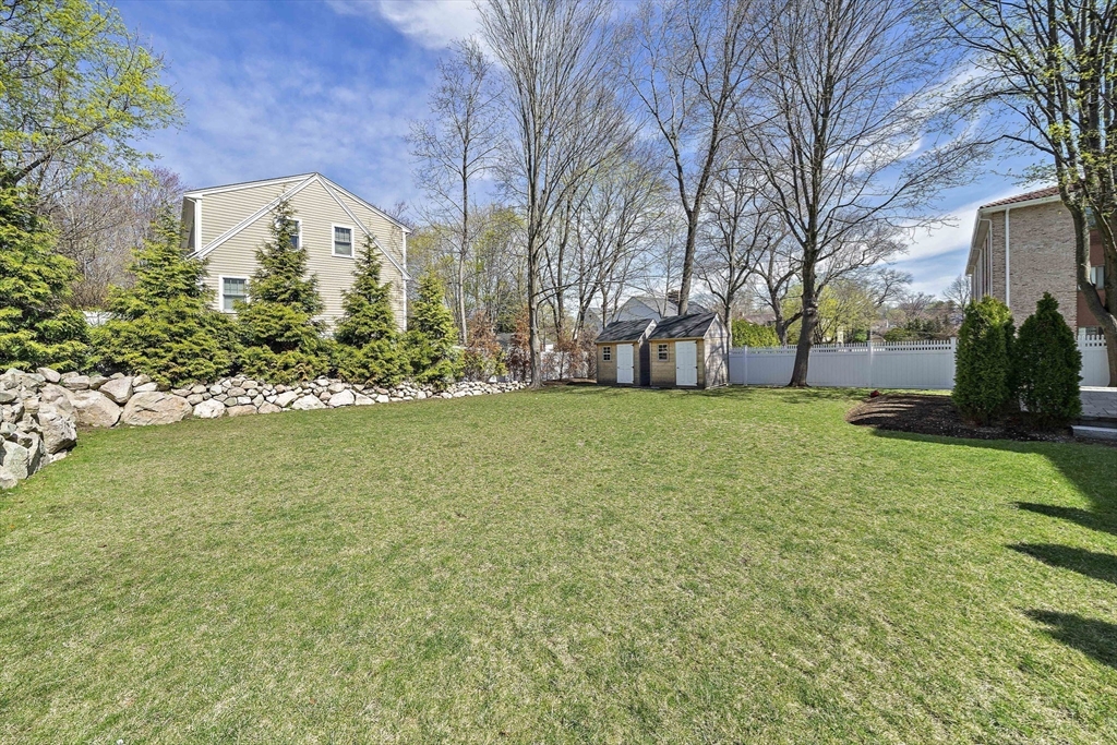 144 Linden Street, Unit 2 Wellesley, MA 02482 - Photo 24 of 28 a view of a yard with a house