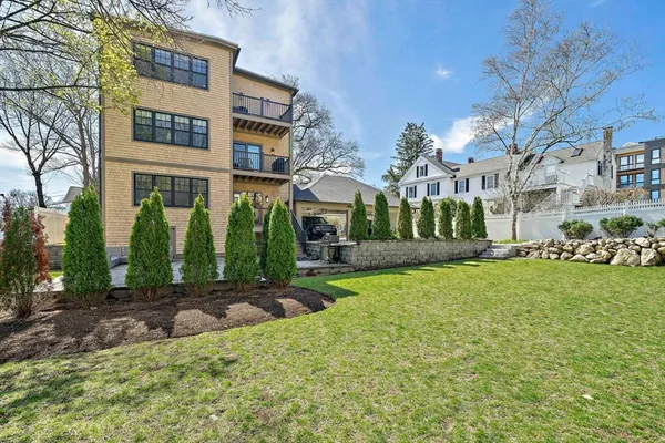 a view of a big building with a big yard and large trees
