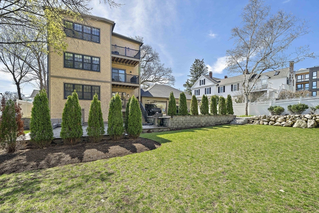 144 Linden Street, Unit 2 Wellesley, MA 02482 - Photo 26 of 28 a view of a big building with a big yard and large trees