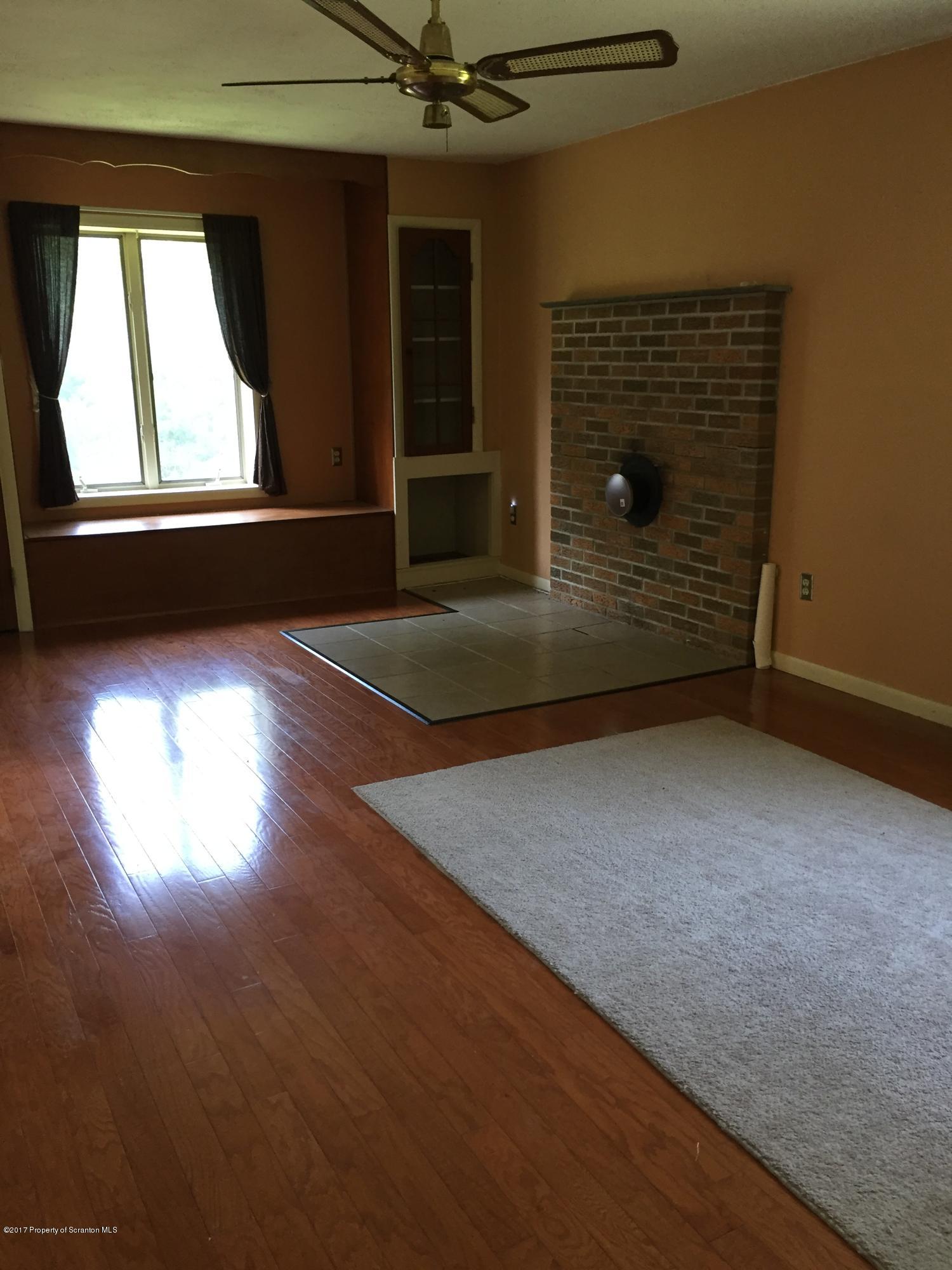 154 Hall Road Meshoppen, PA 18630 - Photo 11 of 35 an empty room with wooden floor and windows