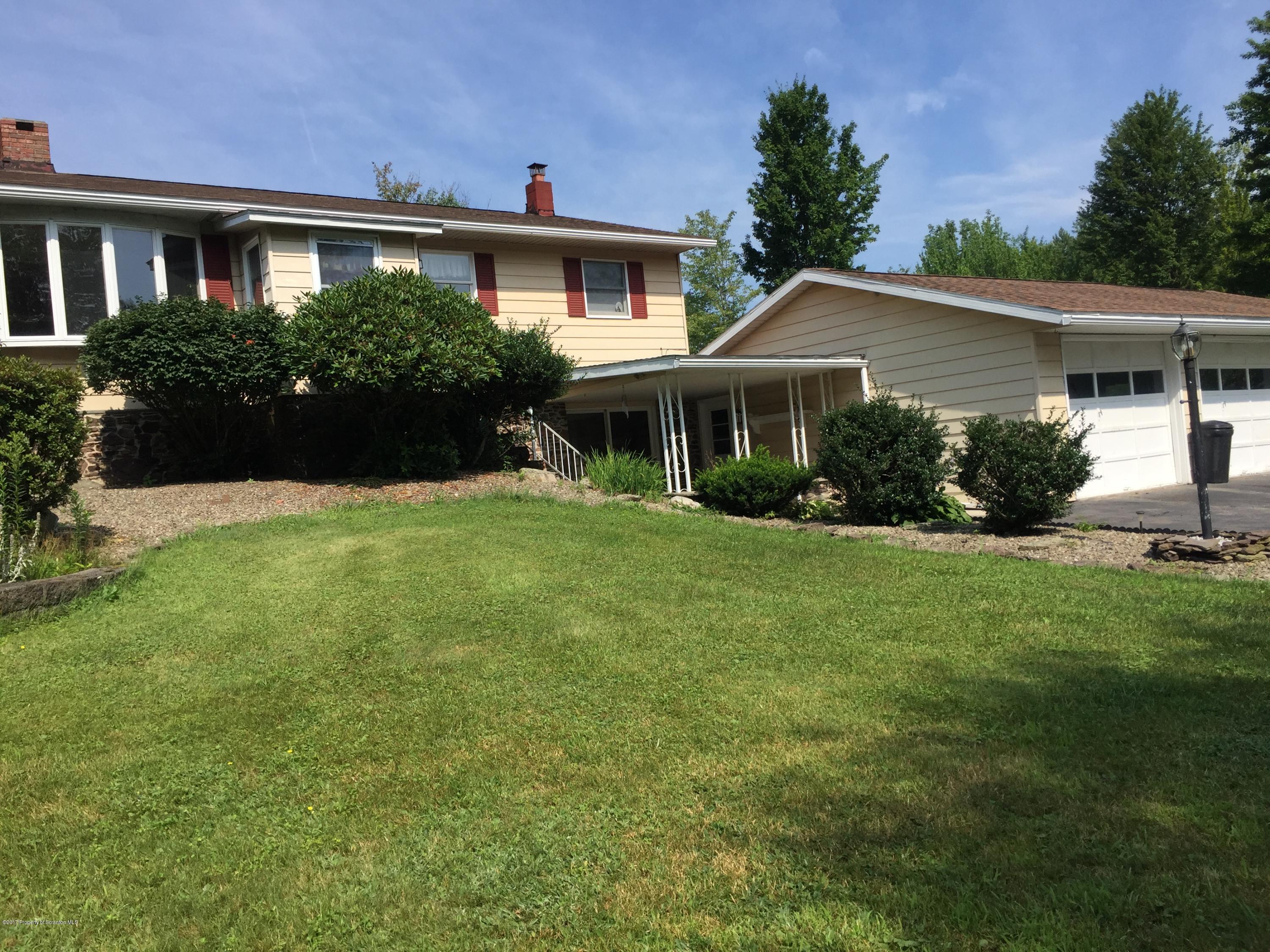 154 Hall Road Meshoppen, PA 18630 - Photo 2 of 35 a front view of a house with a yard and plants