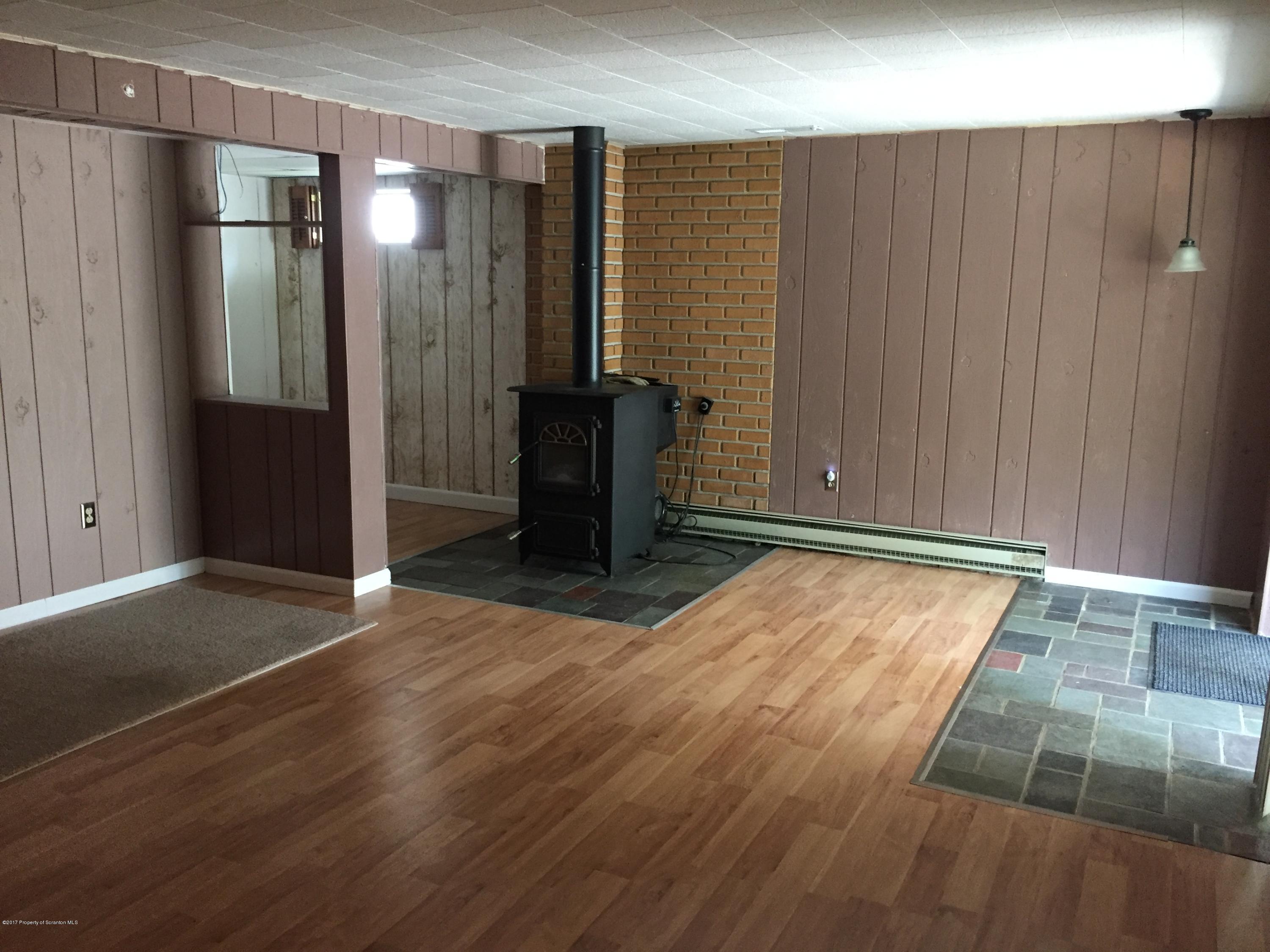 154 Hall Road Meshoppen, PA 18630 - Photo 21 of 35 an empty room with wooden floor and way to kitchen