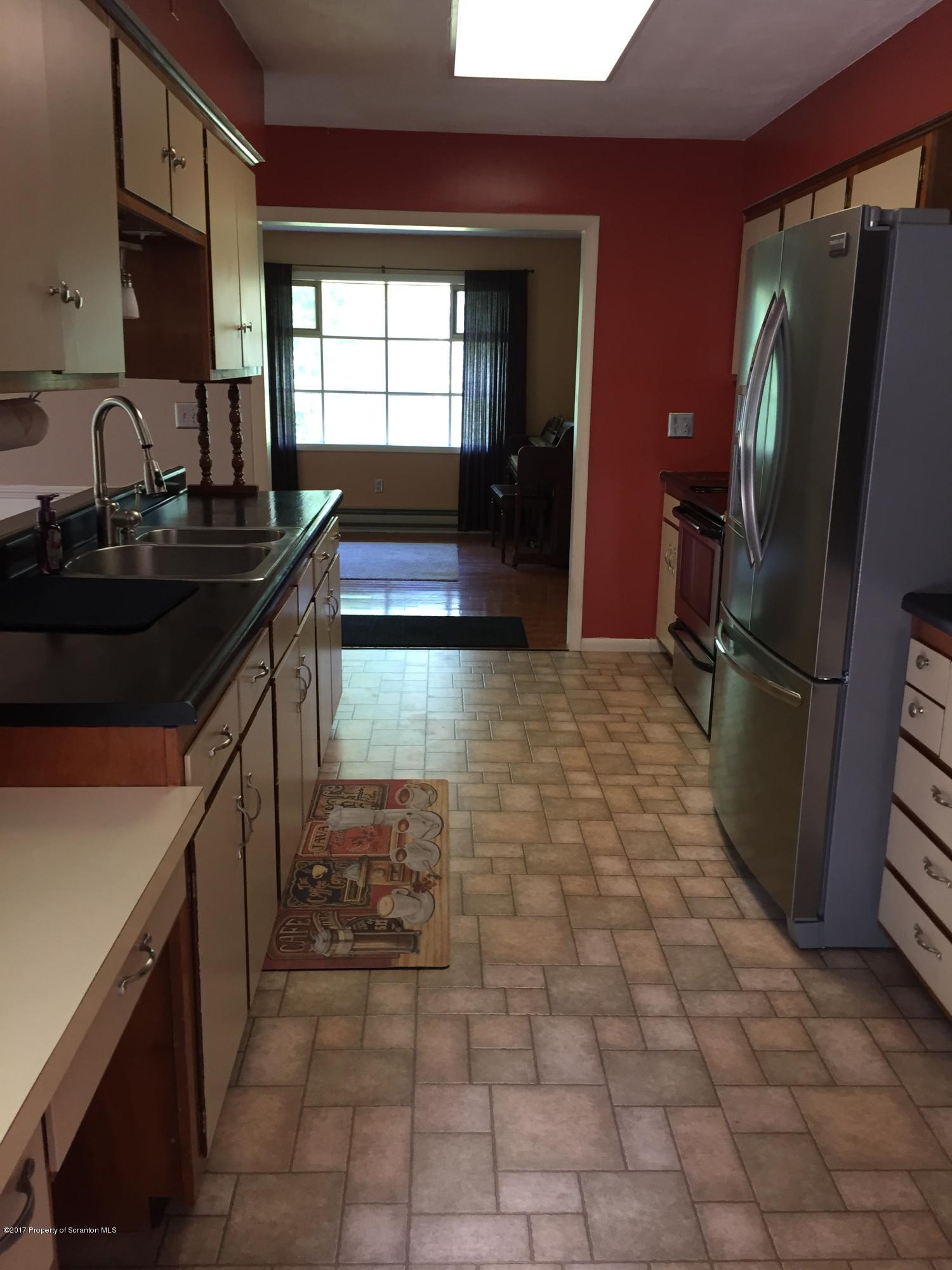 154 Hall Road Meshoppen, PA 18630 - Photo 8 of 35 a kitchen with granite countertop a refrigerator and a sink