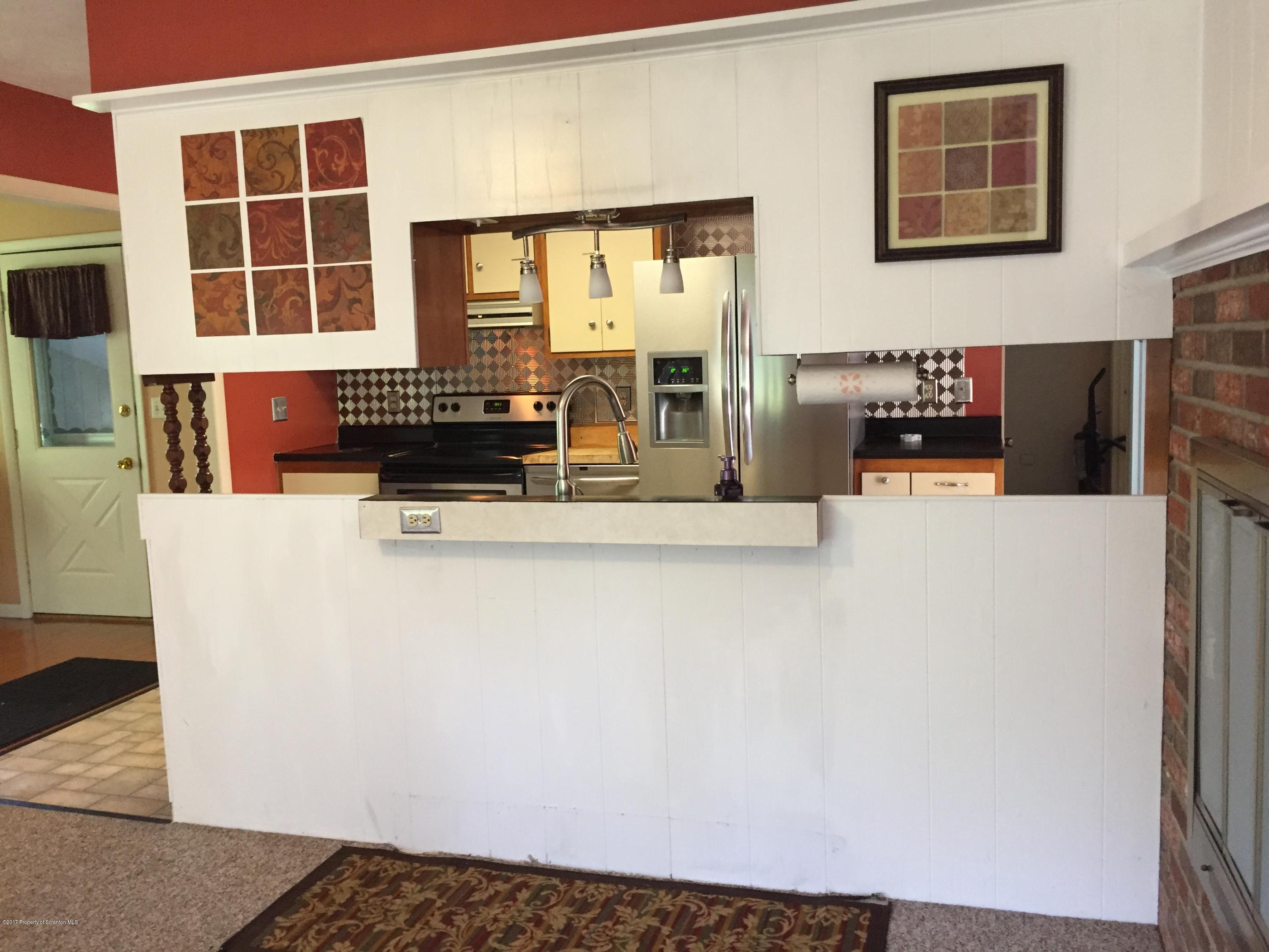 154 Hall Road Meshoppen, PA 18630 - Photo 10 of 35 a kitchen with a refrigerator and a table