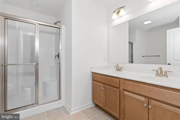 a bathroom with a double vanity sink and mirror