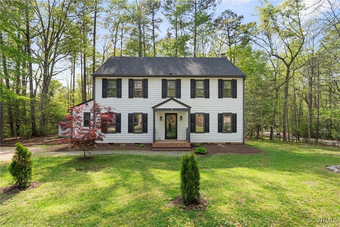 a aerial view of a house with a yard patio and fire pit