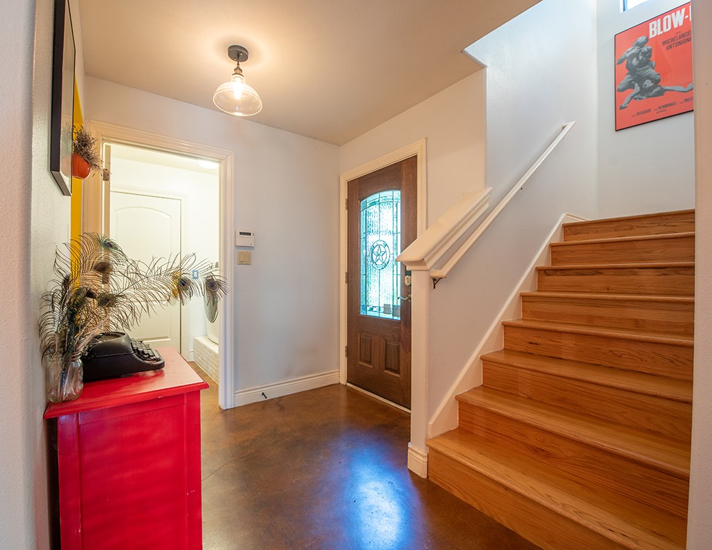 3609 Clawson Road, Unit A Austin, TX 78704 - Photo 16 of 17 A graceful staircase with wood treads ascends from a welcoming entry with a stained glass front door.