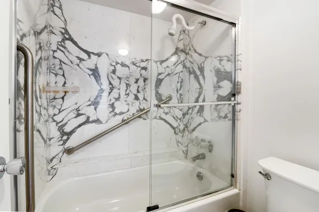 a bathroom with a bathtub and shower