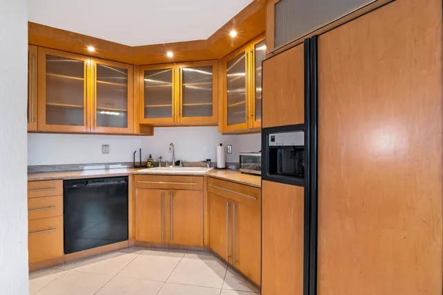 a kitchen with stainless steel appliances granite countertop a sink and cabinets
