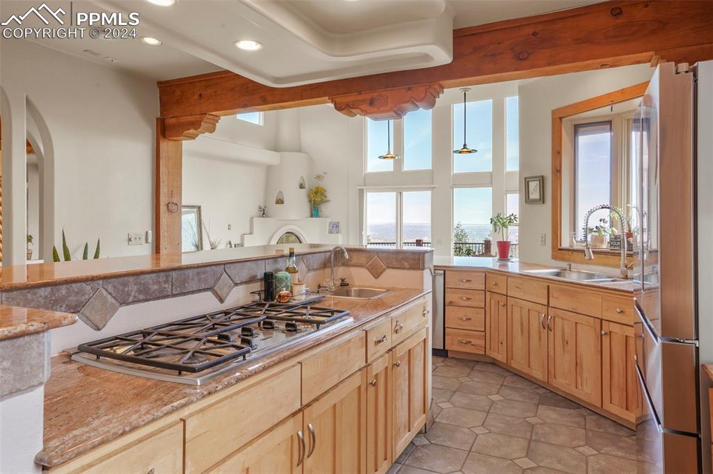 915 Oak Ridge Road Manitou Springs, CO 80829 - Photo 15 of 50 a kitchen with stainless steel appliances granite countertop a stove a sink and a microwave