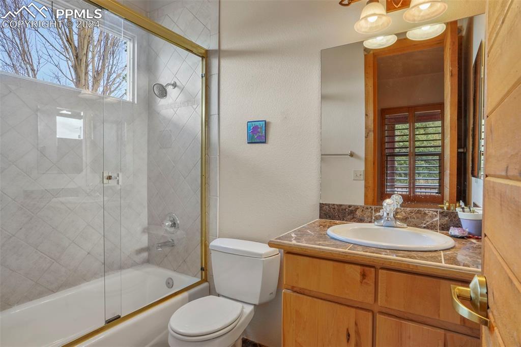 915 Oak Ridge Road Manitou Springs, CO 80829 - Photo 25 of 50 a bathroom with a sink a toilet a mirror and shower