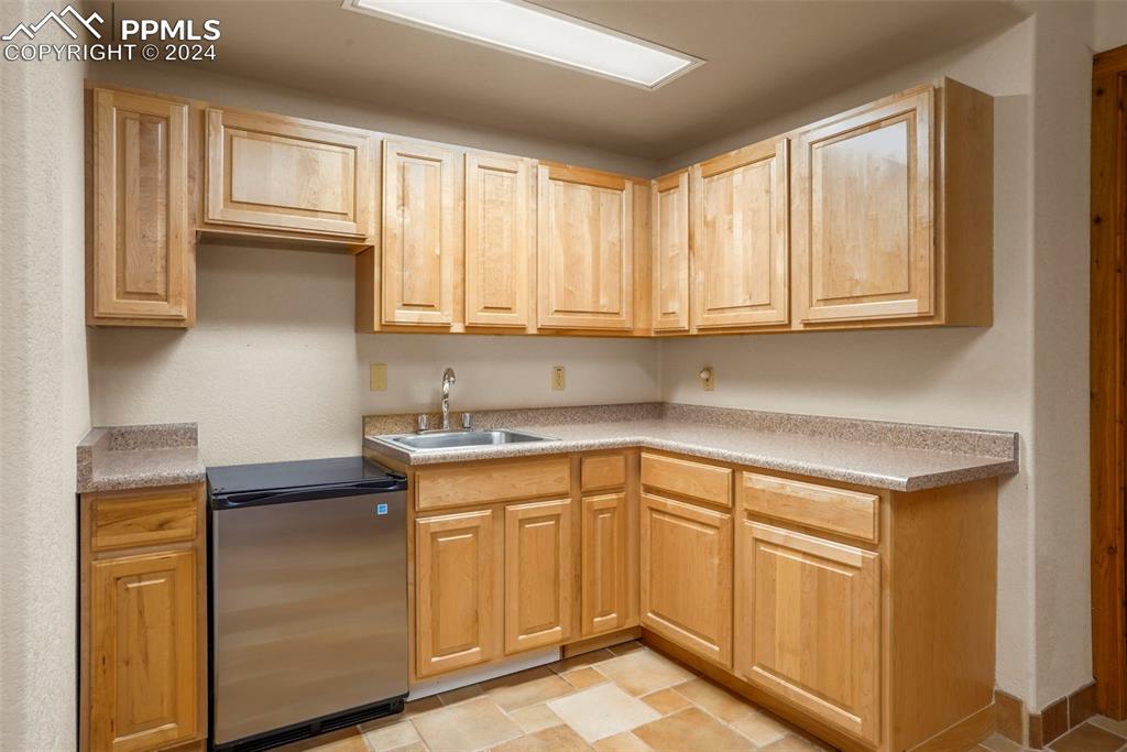 915 Oak Ridge Road Manitou Springs, CO 80829 - Photo 30 of 50 a kitchen with stainless steel appliances granite countertop a sink stove and cabinets