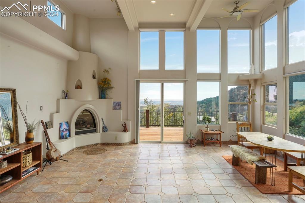 915 Oak Ridge Road Manitou Springs, CO 80829 - Photo 9 of 50 a living room with furniture a fireplace and floor to ceiling window