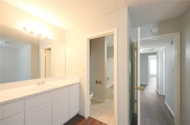 a bathroom with a double vanity sink mirror and shower