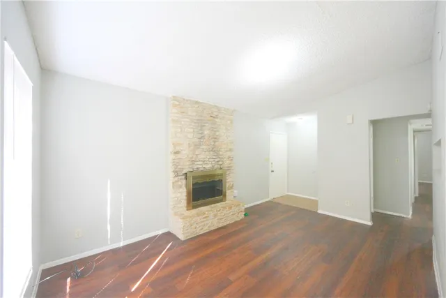 wooden floor in an empty room with a fireplace