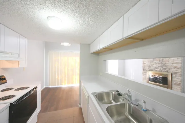 a kitchen with a sink cabinets and a window