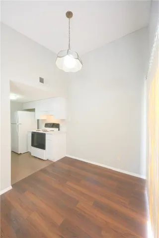 a view of a kitchen with a sink and dishwasher with wooden floor