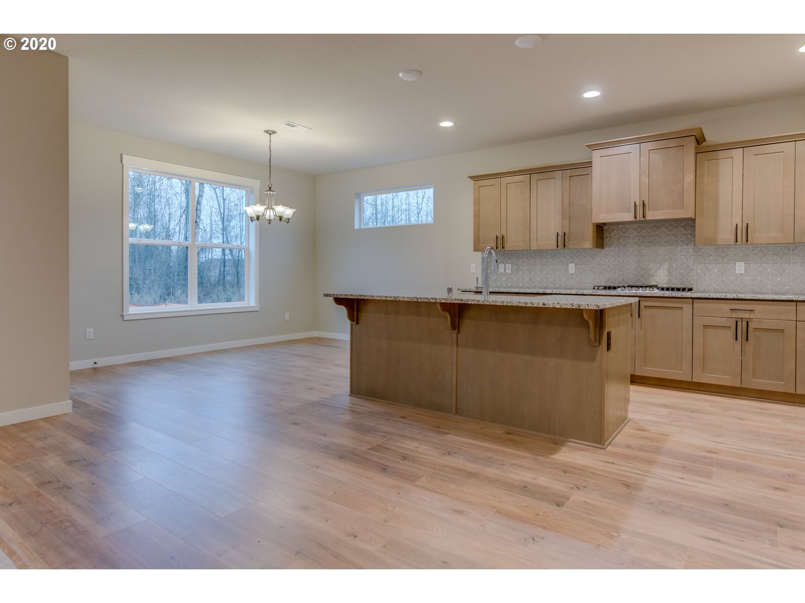 8524 North 1st Street, Unit LT96 Ridgefield, WA 98642 - Photo 11 of 32 a kitchen with stainless steel appliances granite countertop a sink cabinets and wooden floor