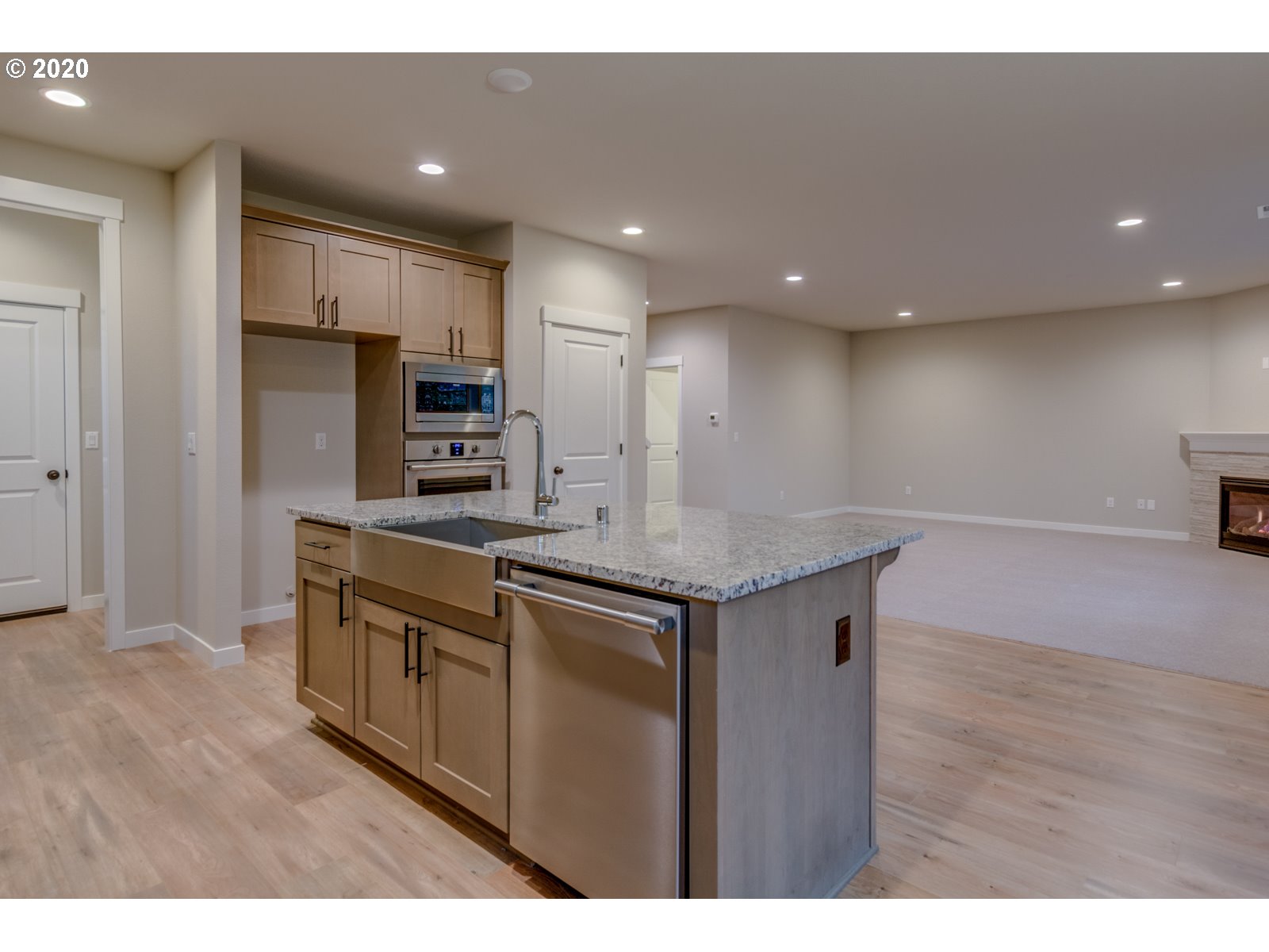8524 North 1st Street, Unit LT96 Ridgefield, WA 98642 - Photo 17 of 32 a kitchen with stainless steel appliances granite countertop a sink a stove a refrigerator and a oven