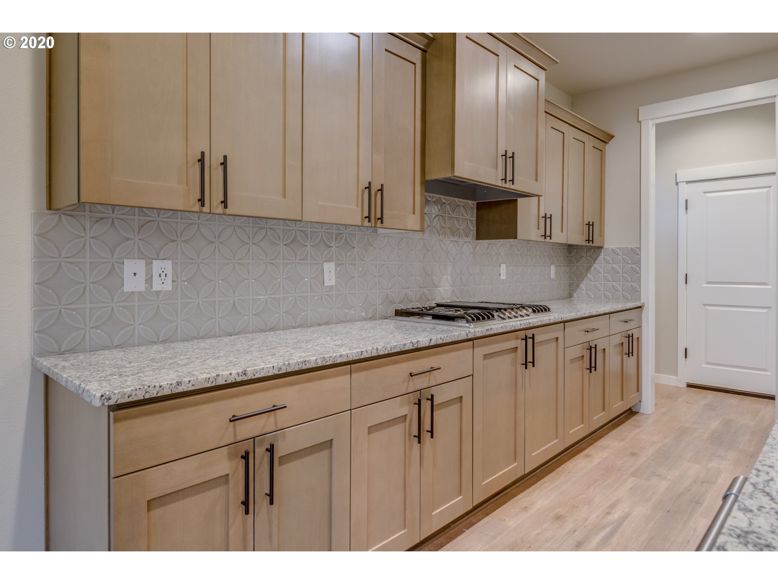 8524 North 1st Street, Unit LT96 Ridgefield, WA 98642 - Photo 19 of 32 a kitchen with granite countertop white cabinets sink and stainless steel appliances