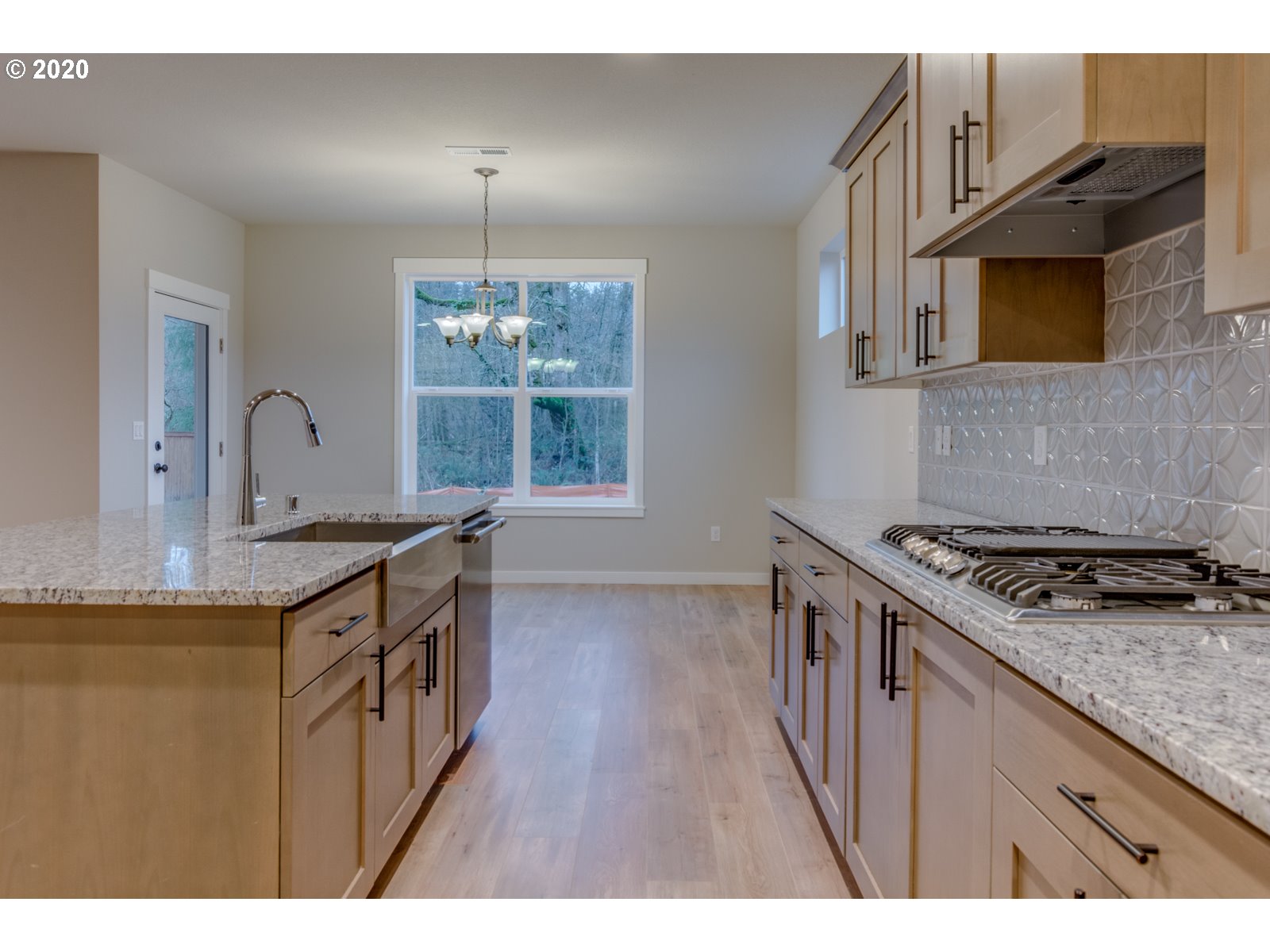 8524 North 1st Street, Unit LT96 Ridgefield, WA 98642 - Photo 22 of 32 a kitchen with granite countertop a stove a sink dishwasher and a microwave oven with large wooden cabinets