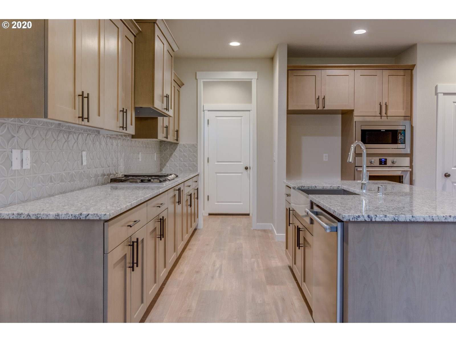 8524 North 1st Street, Unit LT96 Ridgefield, WA 98642 - Photo 23 of 32 a kitchen with granite countertop a sink a counter top space stainless steel appliances and cabinets