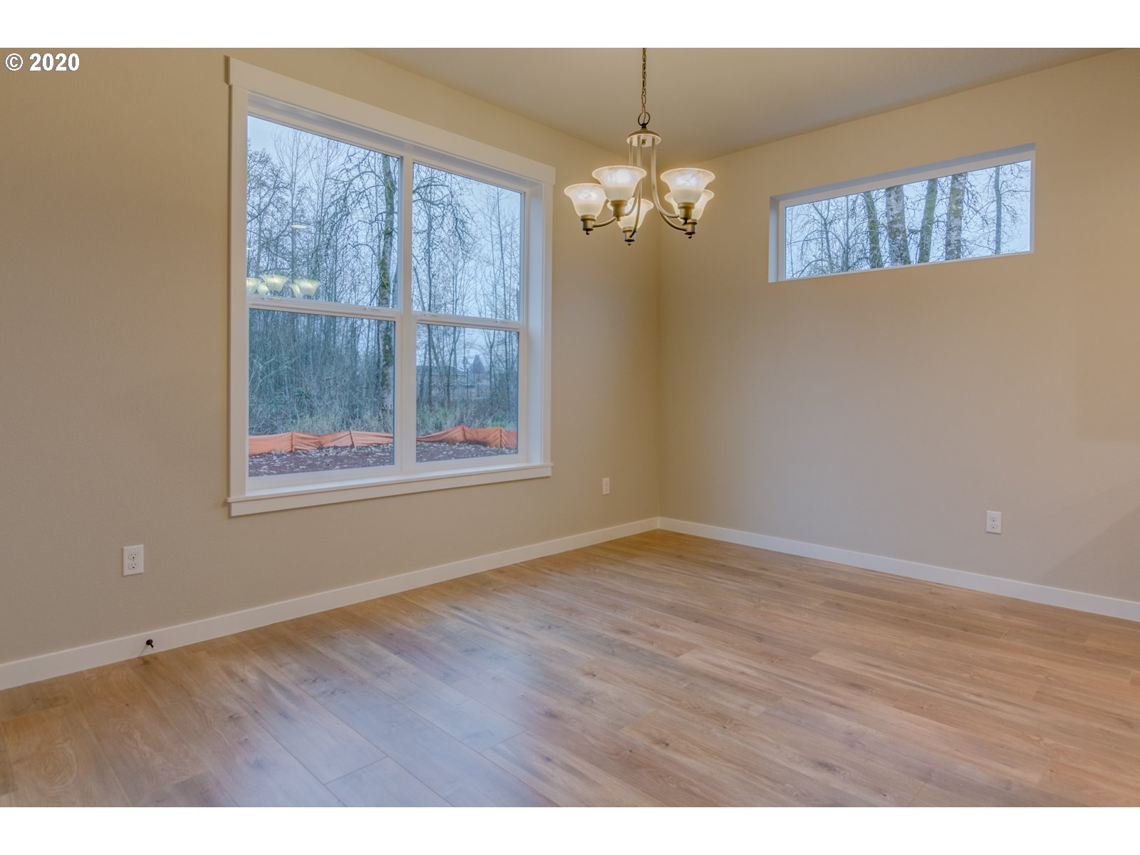 8524 North 1st Street, Unit LT96 Ridgefield, WA 98642 - Photo 24 of 32 an empty room with wooden floor chandelier and windows