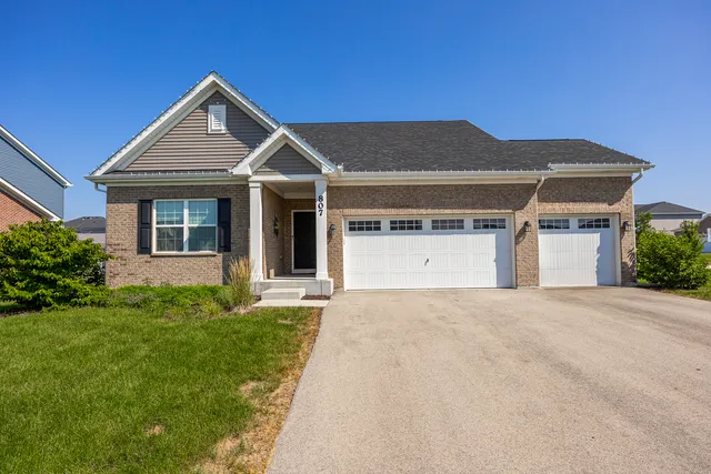 a front view of a house with a yard and garage