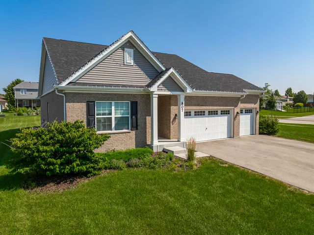 a front view of a house with a yard and garage