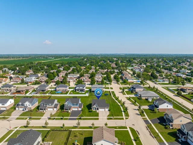 an aerial view of residential houses with outdoor space
