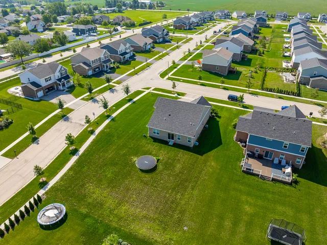 an aerial view of a house with garden space and street view