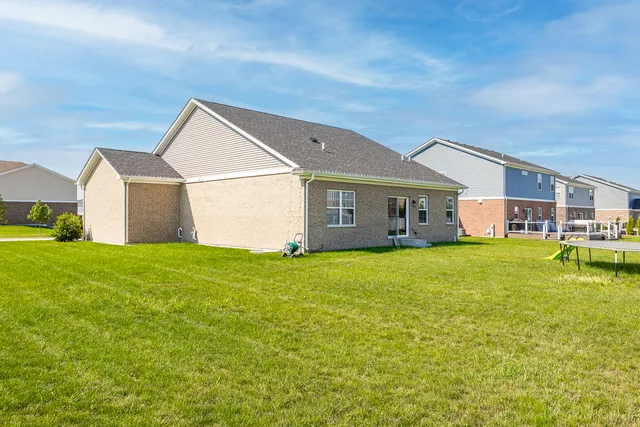 a view of a house with a backyard