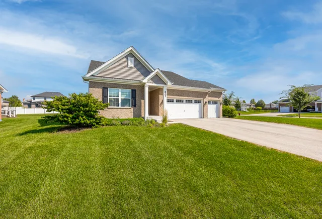 a front view of a house with a yard and garage