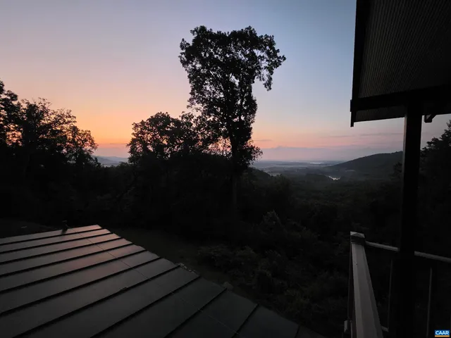 a view of a balcony with a yard
