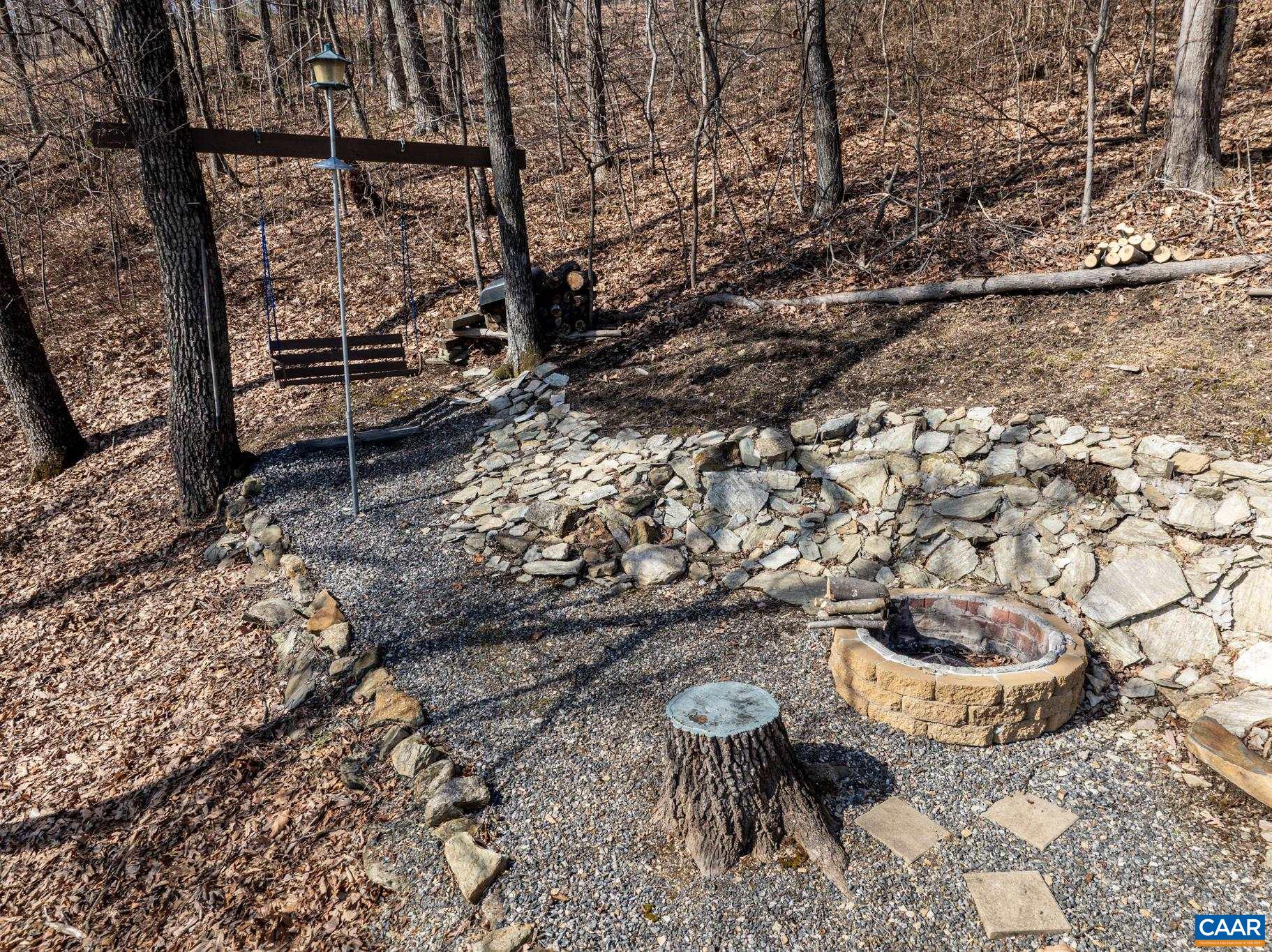 1022 Turkey Ridge Road Stanardsville, VA 22973 - Photo 17 of 74 a view of a backyard with chair and an umbrella