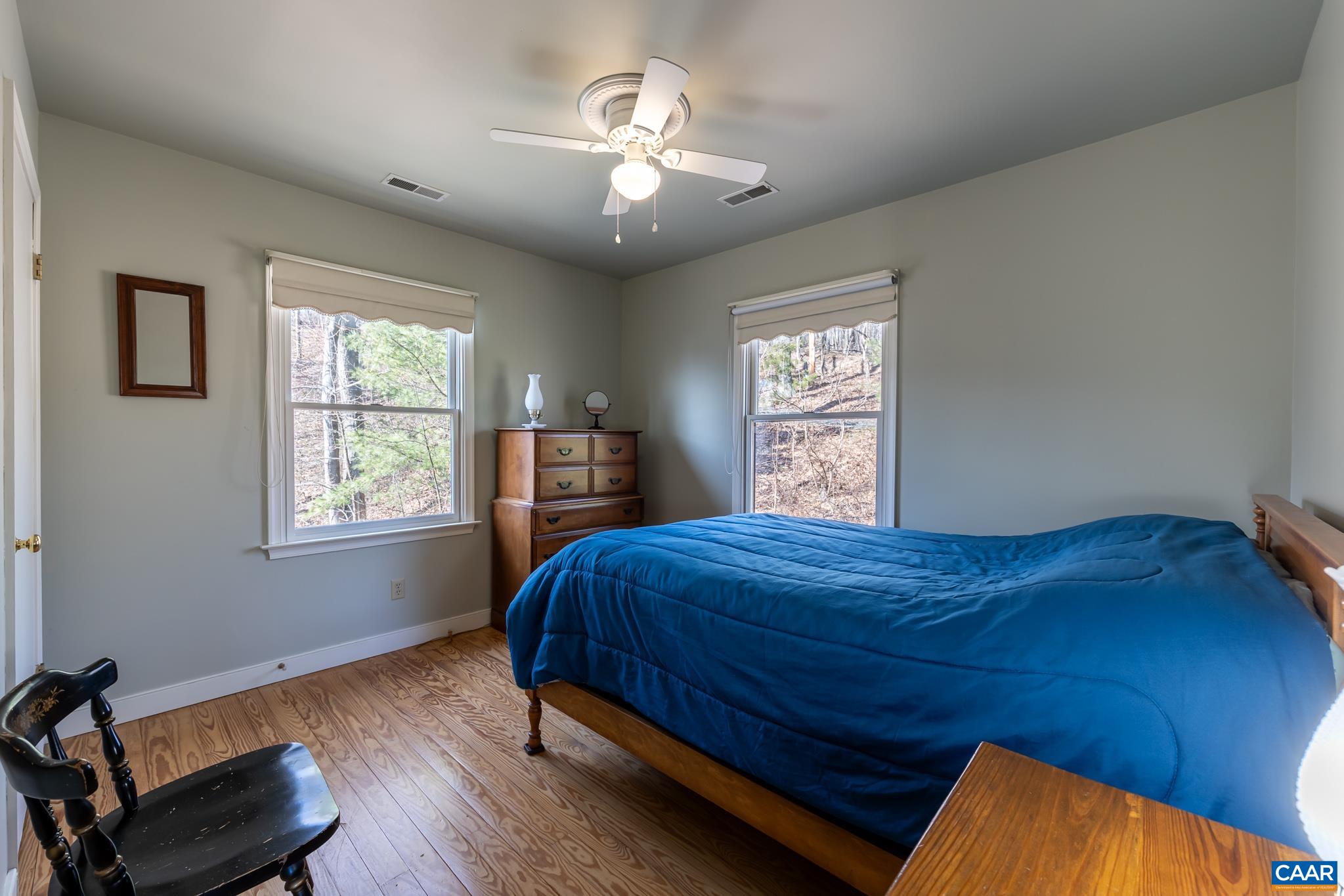 1022 Turkey Ridge Road Stanardsville, VA 22973 - Photo 47 of 74 a bed sitting in a bedroom next to a window