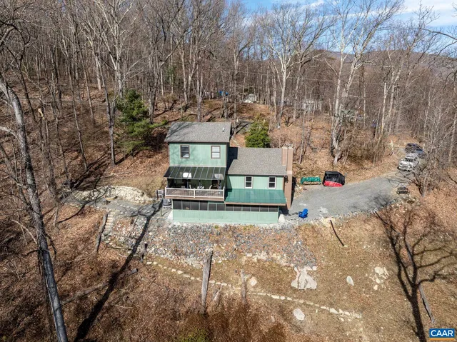 a view of a dry field with mountains in the background