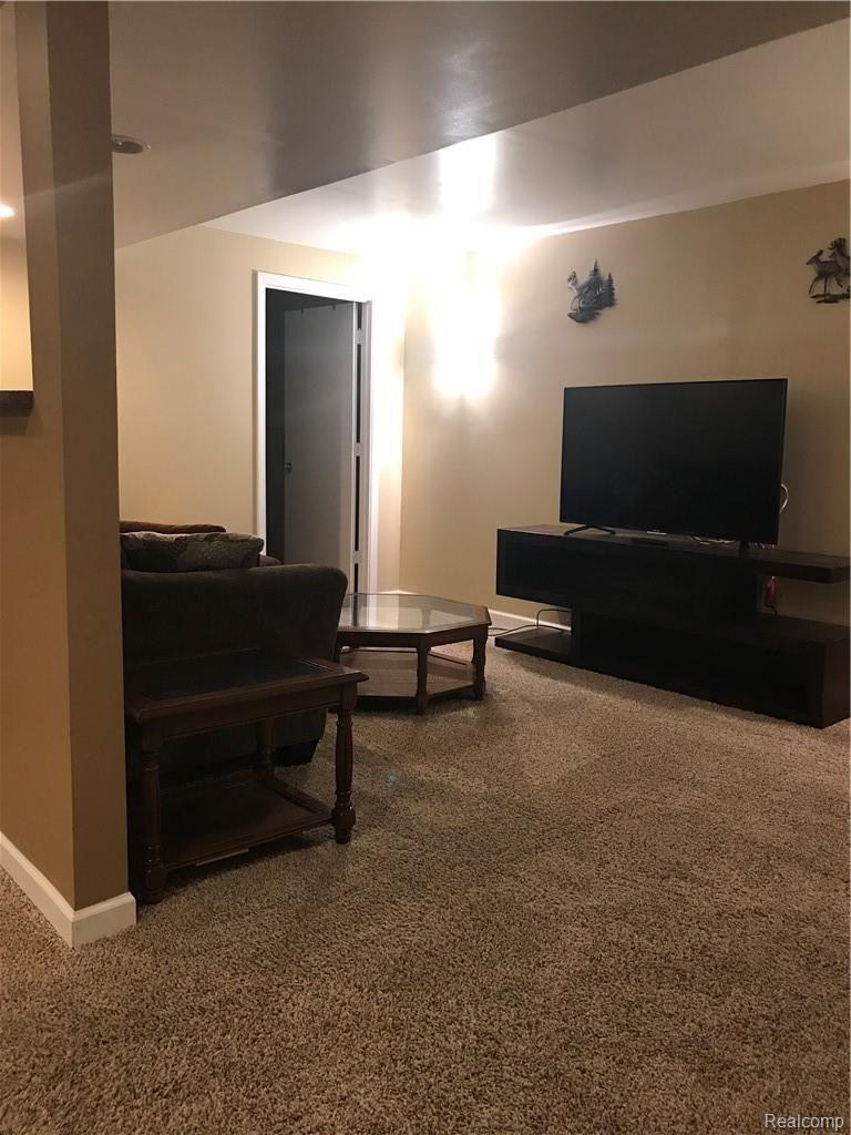 7582 West Beard Road Perry, MI 48872 - Photo 22 of 35 Family room with bath in corner lower level.