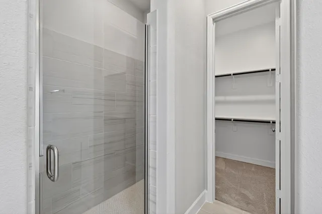 a bathroom with a glass shower door