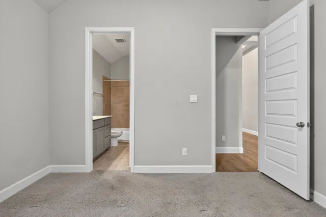 a view of an empty room and closet area