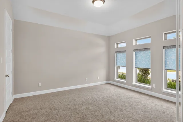 a view of a yard in front of a house with large trees