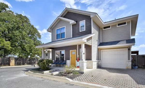 a front view of a house with yard and seating area