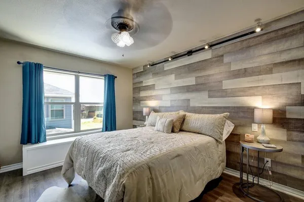 a living room with a fireplace a flat screen tv and a sink