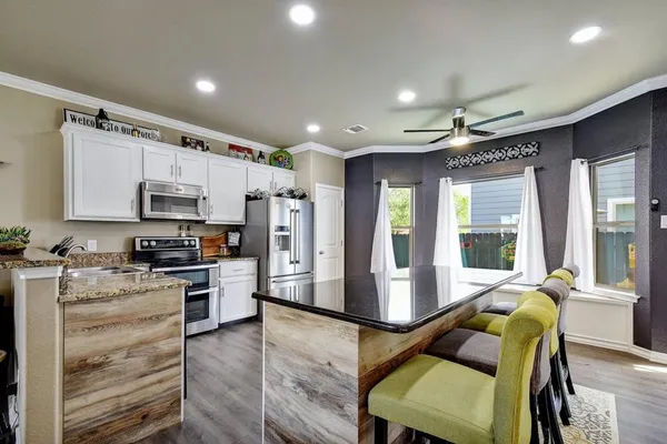 a kitchen with stainless steel appliances and white cabinets