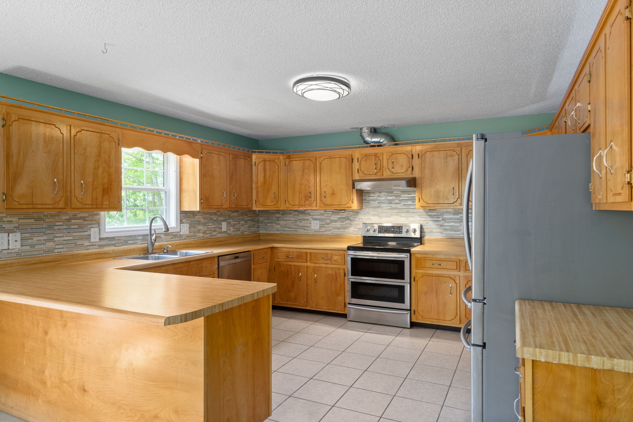 3315 Lylewood Road Woodlawn, TN 37191 - Photo 12 of 39 a kitchen with stainless steel appliances granite countertop a sink and a stove