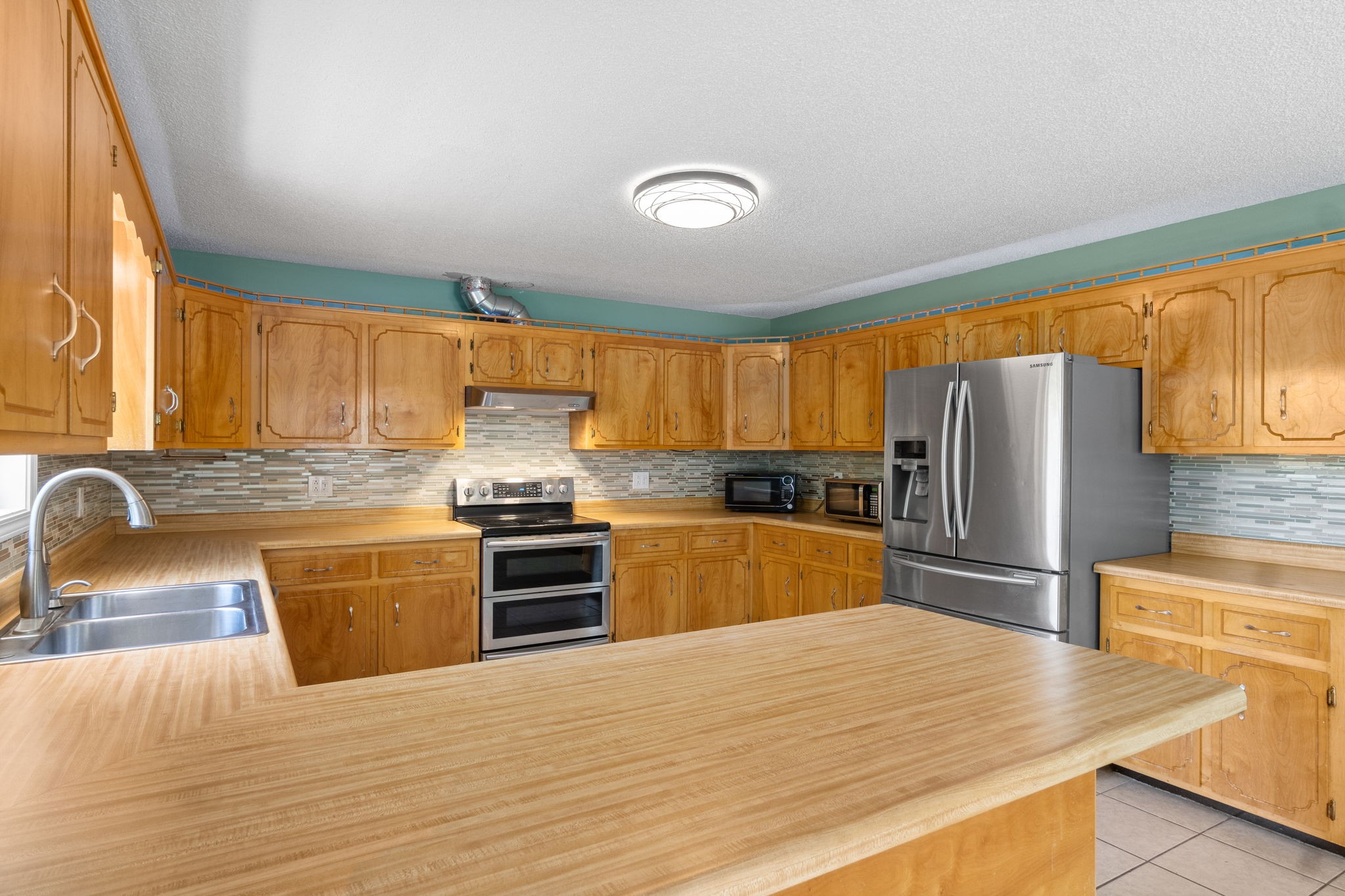 3315 Lylewood Road Woodlawn, TN 37191 - Photo 13 of 39 a kitchen with stainless steel appliances granite countertop a sink stove and refrigerator