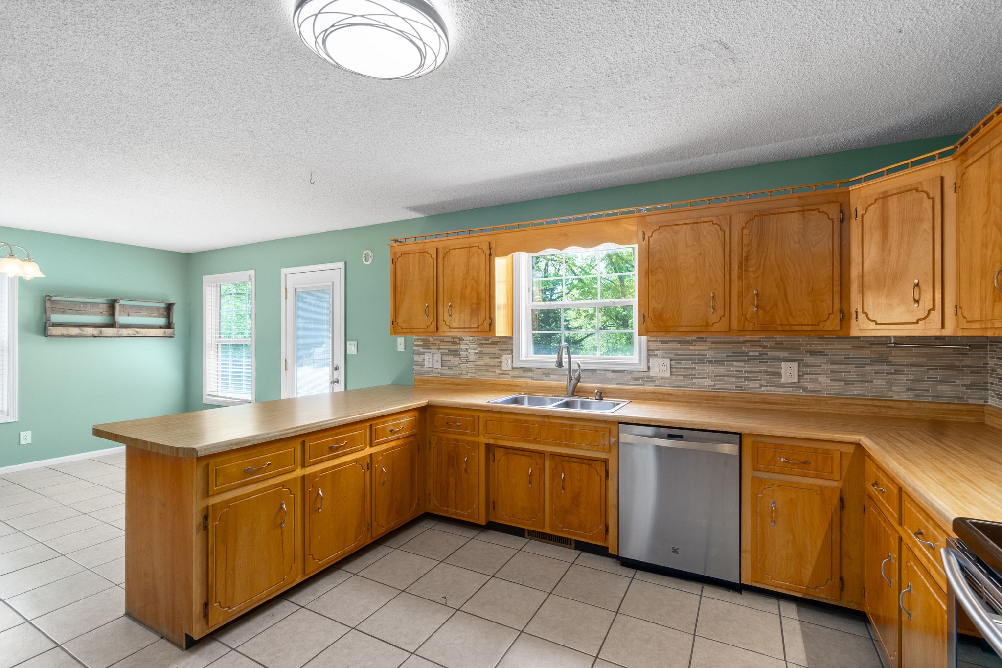 3315 Lylewood Road Woodlawn, TN 37191 - Photo 14 of 39 a kitchen with a sink window and cabinets