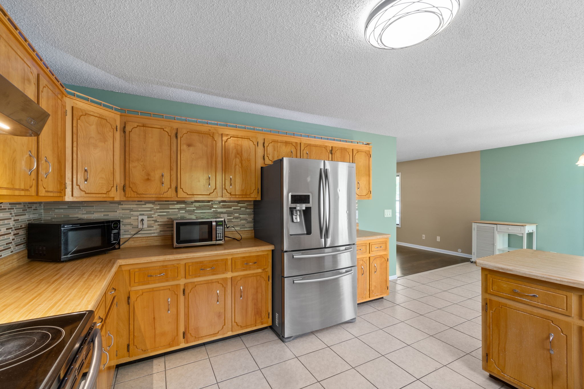 3315 Lylewood Road Woodlawn, TN 37191 - Photo 16 of 39 a kitchen with stainless steel appliances granite countertop a refrigerator a stove and a sink