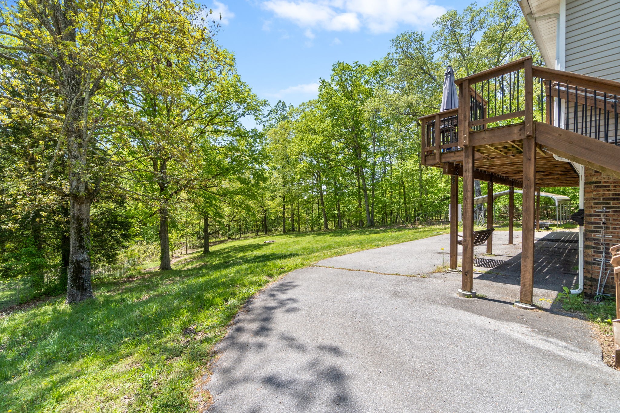 3315 Lylewood Road Woodlawn, TN 37191 - Photo 31 of 39 a view of a street with potted plants and large trees
