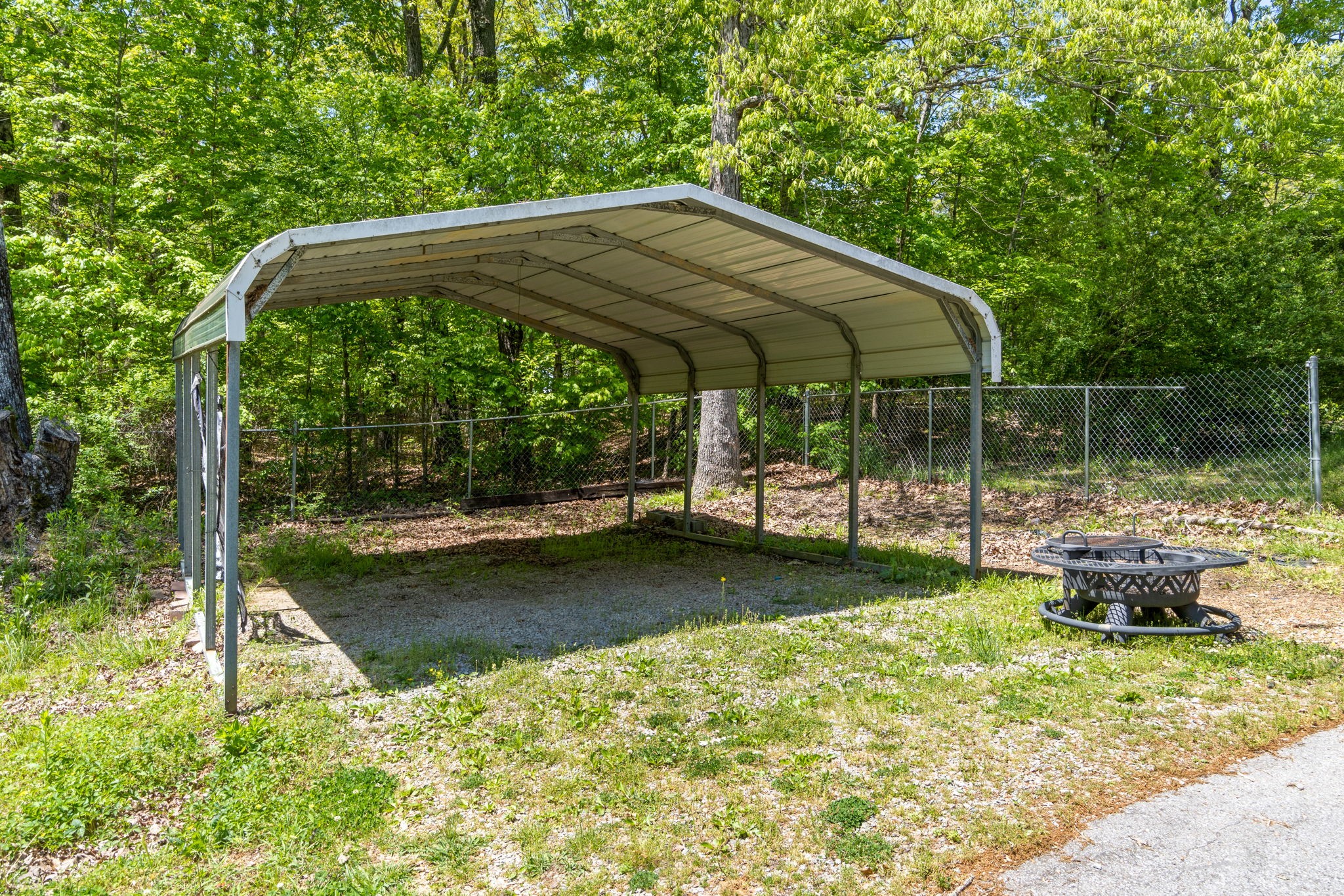 3315 Lylewood Road Woodlawn, TN 37191 - Photo 32 of 39 a backyard of a house with fountain table and chairs